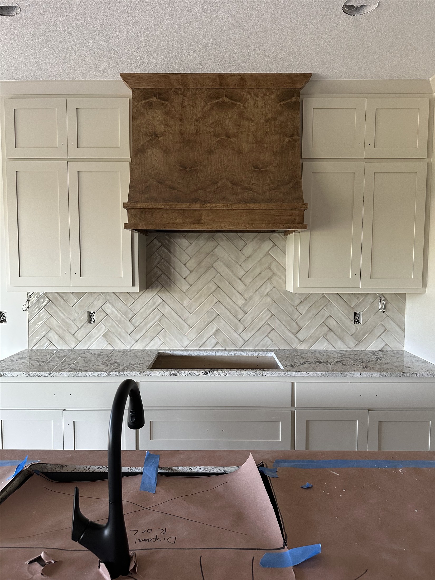 Herringbone kitchen backsplash installed by Heartland Tile